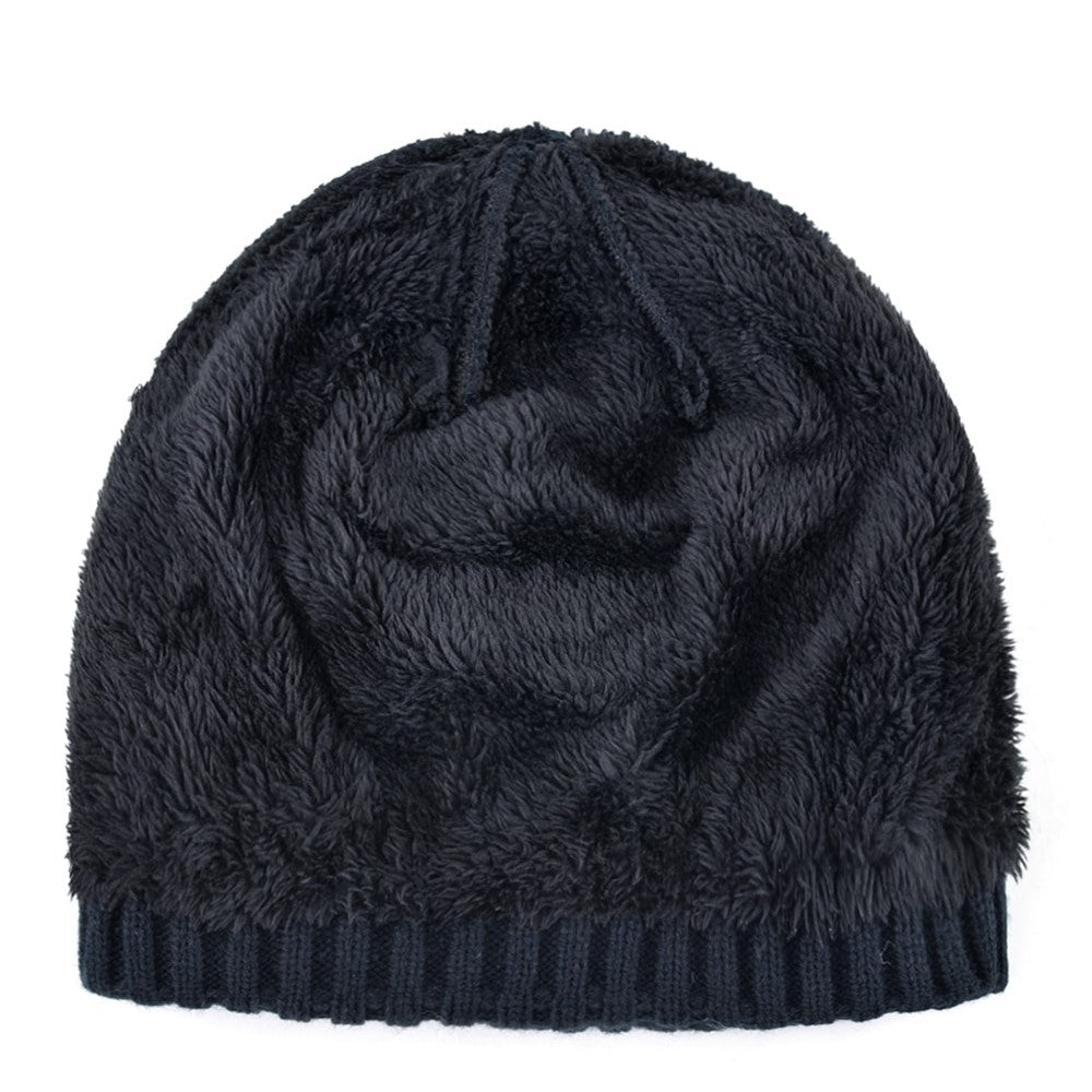 Cozy black winter beanie, soft fur texture, ideal for chilly days and stylish street looks.