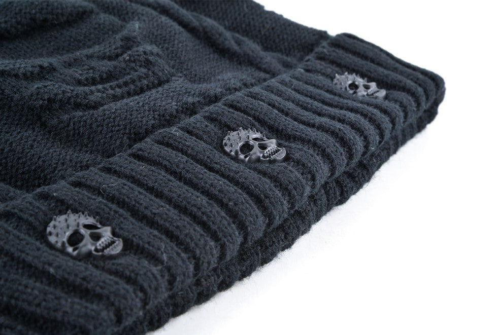 Black knitted wool beanie with ribbed hem and skull decor for a stylish winter look.