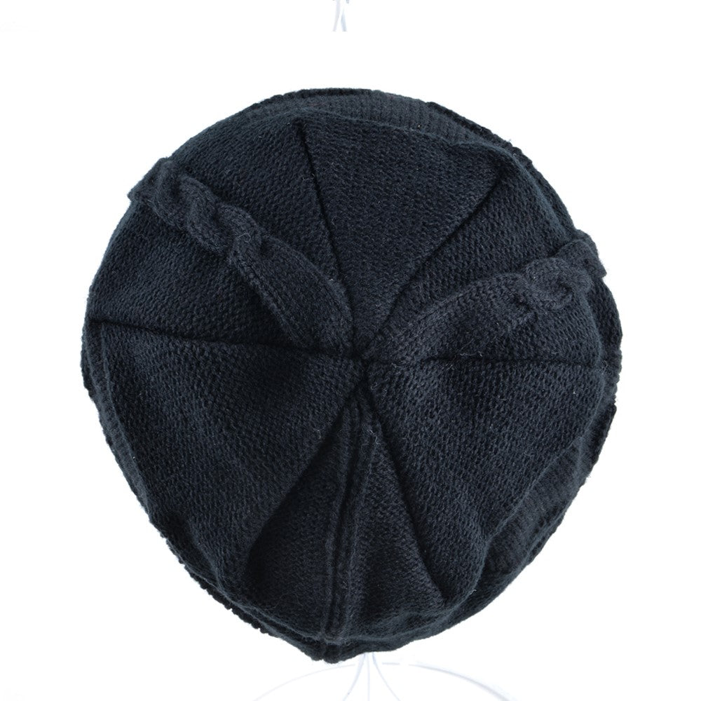 Top view of a black knitted wool beanie featuring a unique skull pattern for winter fashion.