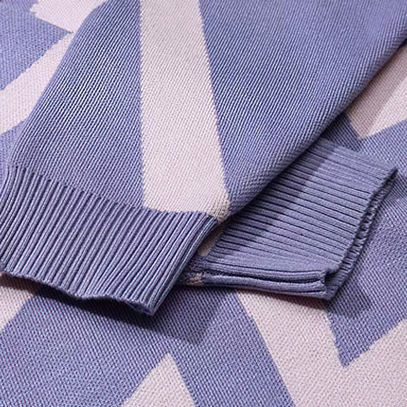 Close-up of a men's knitted hoodie showcasing the stylish sleeve cuffs and unique purple geometric pattern.