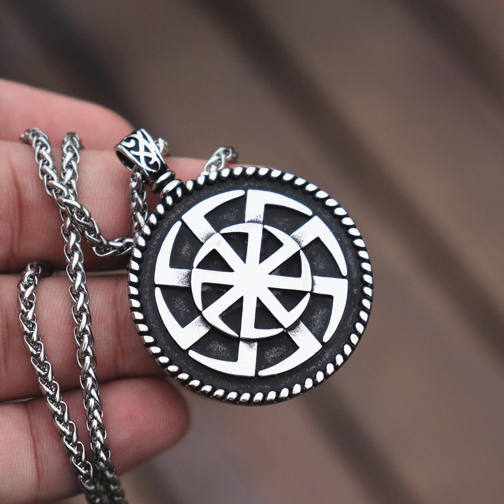 Kolovrat Pagan stainless steel pendant showcasing intricate Slavic sun design on a silver chain.