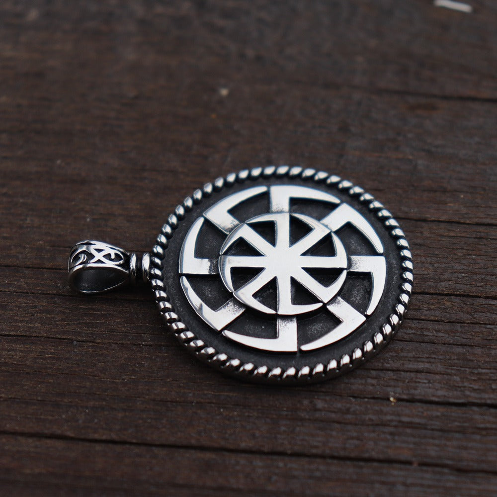 Kolovrat Pagan stainless steel pendant featuring Slavic sun symbol on a wooden background, perfect for jewelry lovers.
