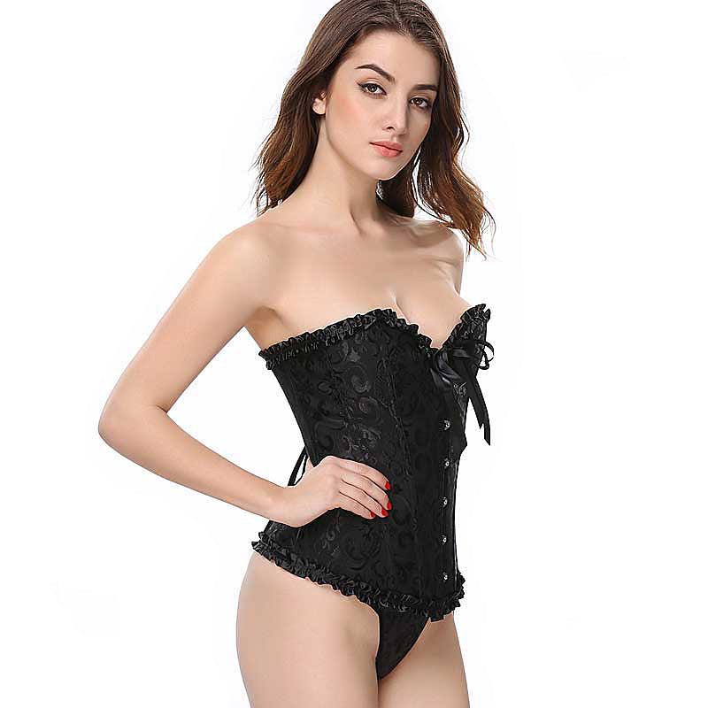 Plus size lace-up gothic corset in black, featuring floral design and ruffled trim, styled with matching thong.