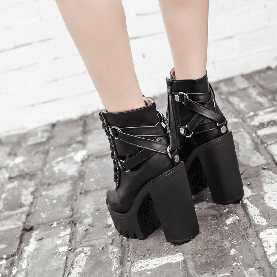 Back view of black lace-up PU leather platform boots for women, featuring chunky heels and stylish decorative straps.