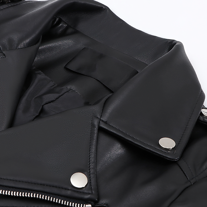 Close-up of the interior of a ladies' black PU leather biker jacket with silver snap buttons, showcasing stylish details.