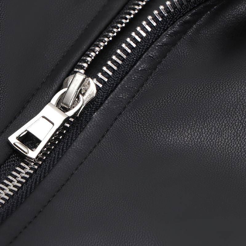 Close-up of a silver zipper on a black PU leather biker jacket, highlighting stylish rock-inspired details.