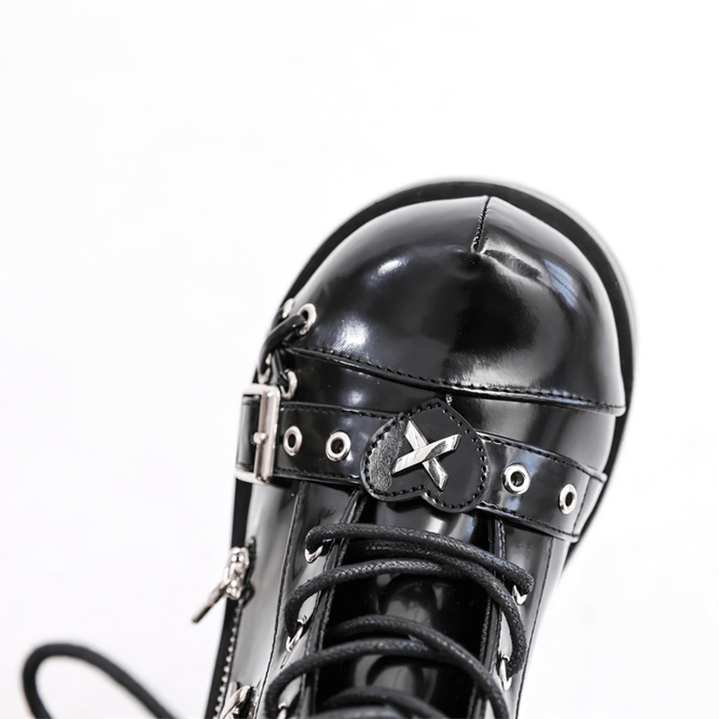Close-up of black goth buckle platform ankle boot with shiny finish and decorative rivets, perfect for punk fashion.