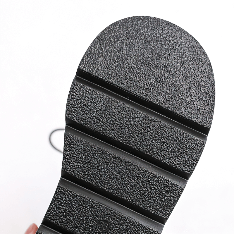 Close-up of the textured sole of ladies goth buckle platform ankle boots, showcasing its sturdy design and grip.