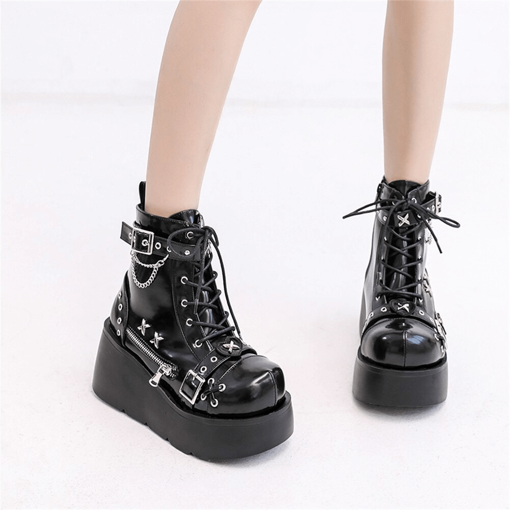 Ladies goth buckle platform ankle boots showcasing stylish black design and punk rivet details for a bold fashion statement.