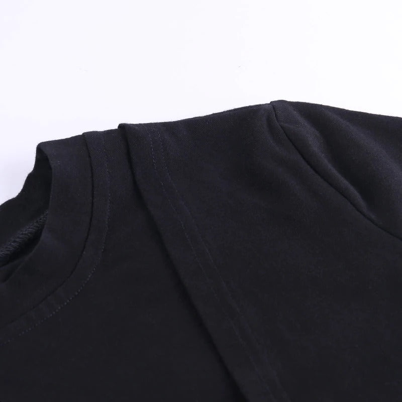 Close-up of a black gothic-style crop top showcasing its asymmetrical design and high-quality fabric.