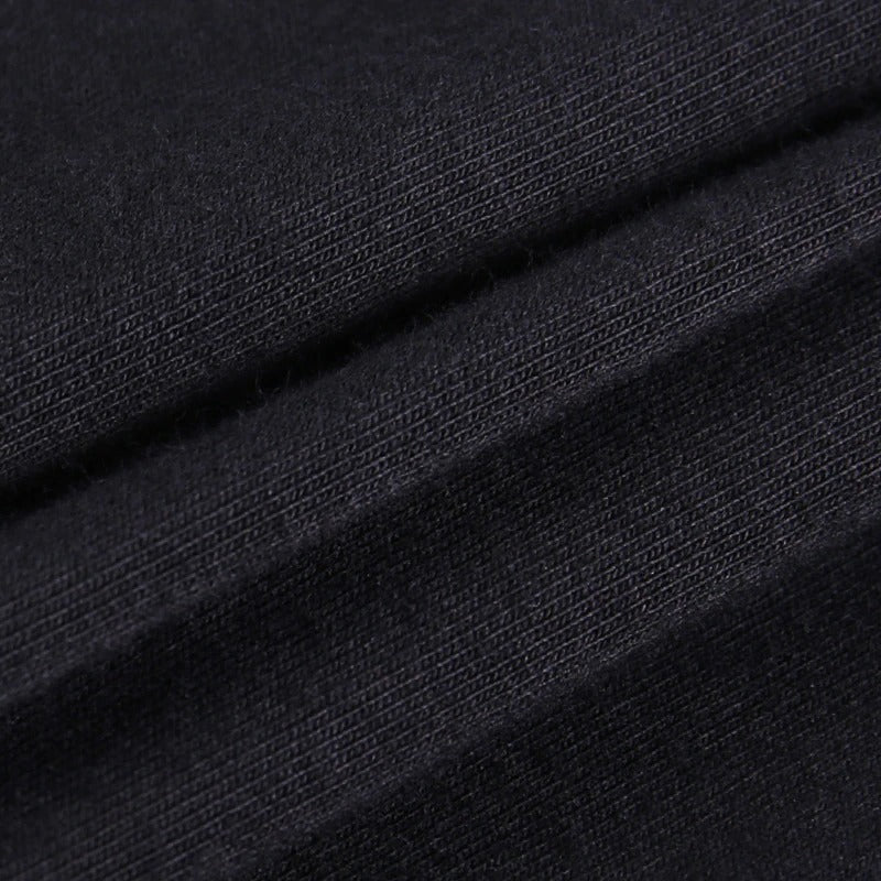 Close-up of soft black fabric ideal for gothic style crop tops, showcasing texture and depth.