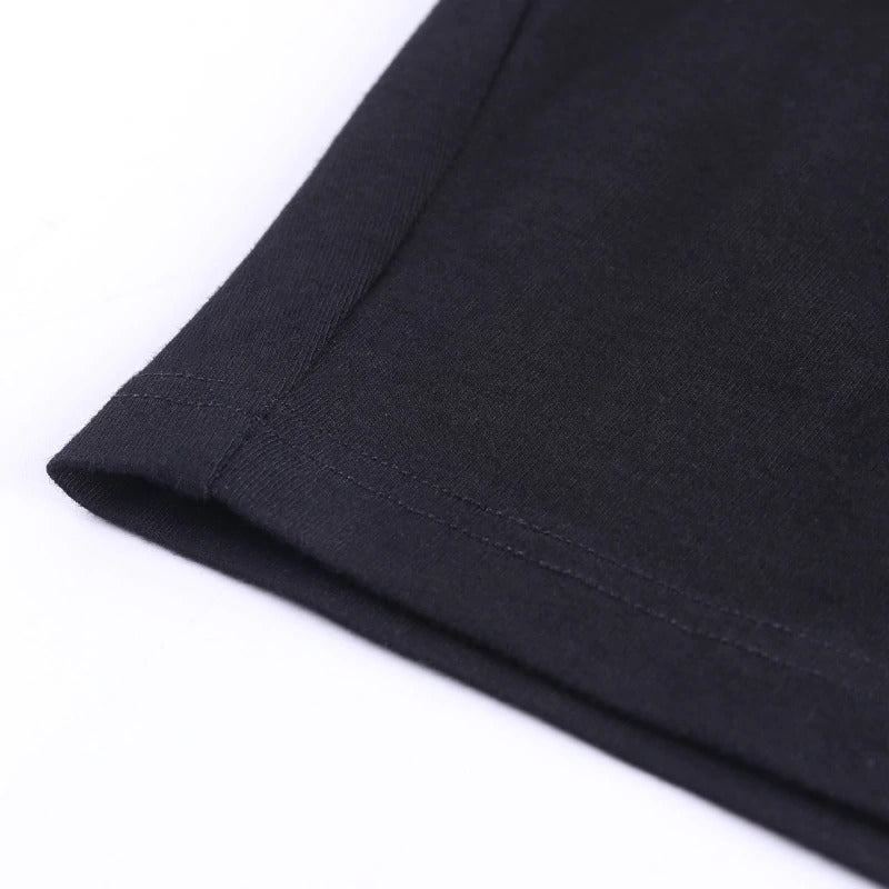 Close-up of the hem of a gothic style black crop top, showcasing neat stitching and soft fabric detail.