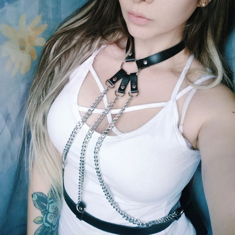Ladies leather body harness with metal chains and straps, stylish alternative accessory for bold fashion statements.