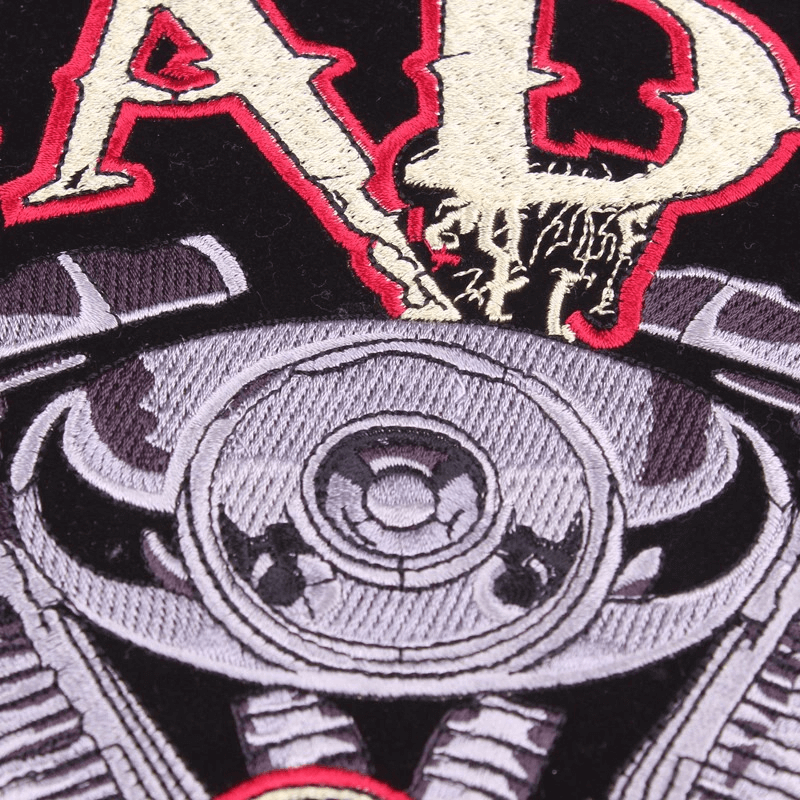 Close-up of a large embroidered biker patch featuring a motorcycle engine design and bold lettering, perfect for jackets.