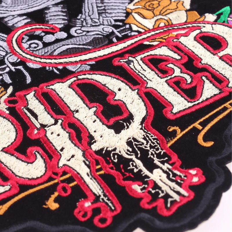 Close-up of a large embroidered lady rider patch featuring bold lettering and intricate biker-themed design elements.