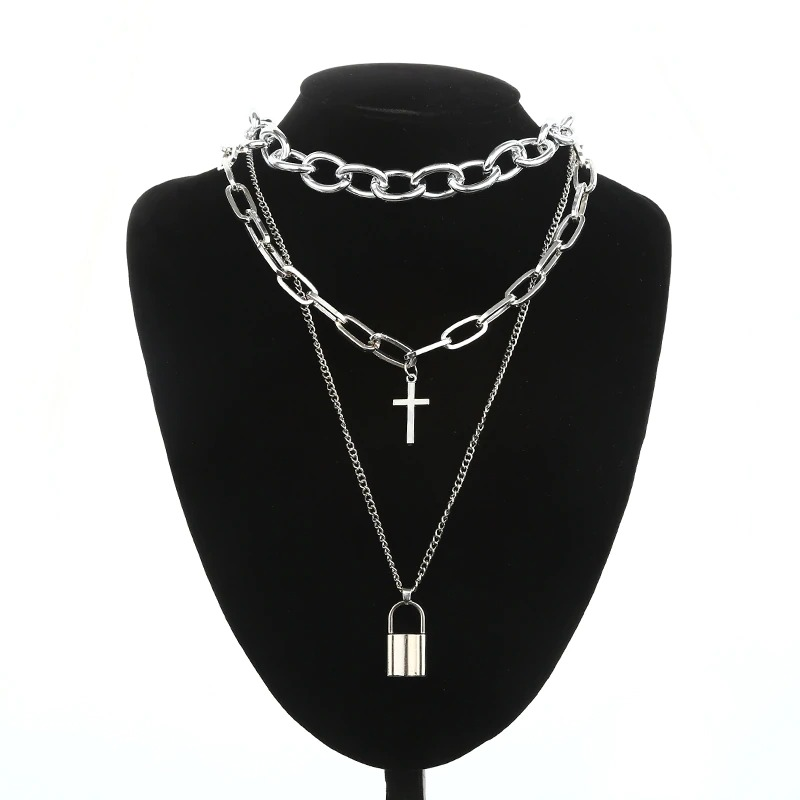 Layered silver chain necklace with cross and padlock pendants, showcasing punk style for unisex fashion.