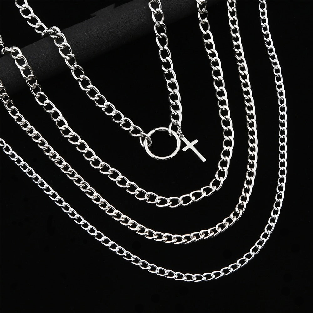 Layered silver chain necklace with cross and ring, perfect unisex choker for stylish outfits.