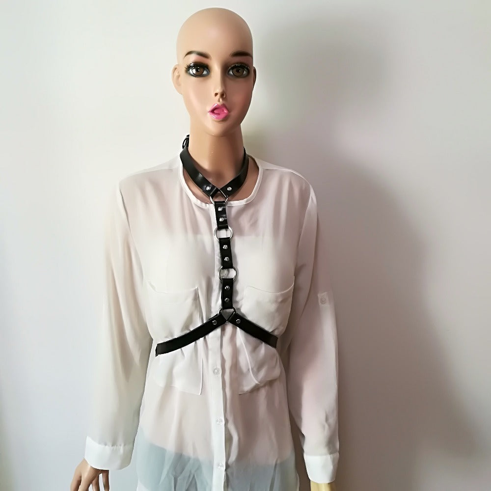 Fashionable gothic leather harness belt for women worn over a sheer white blouse, showcasing unique style.