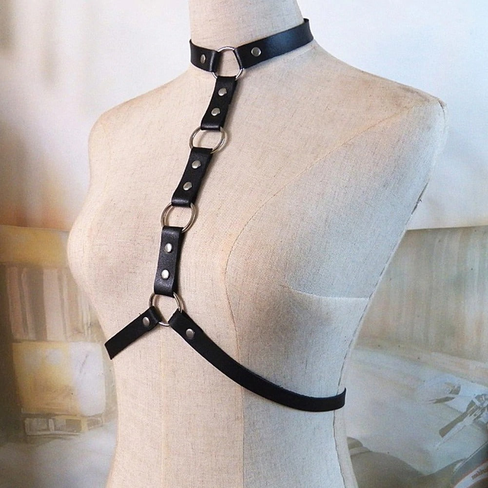 Stylish gothic leather body harness with rings and rivets, perfect for cosplay or festival outfits.