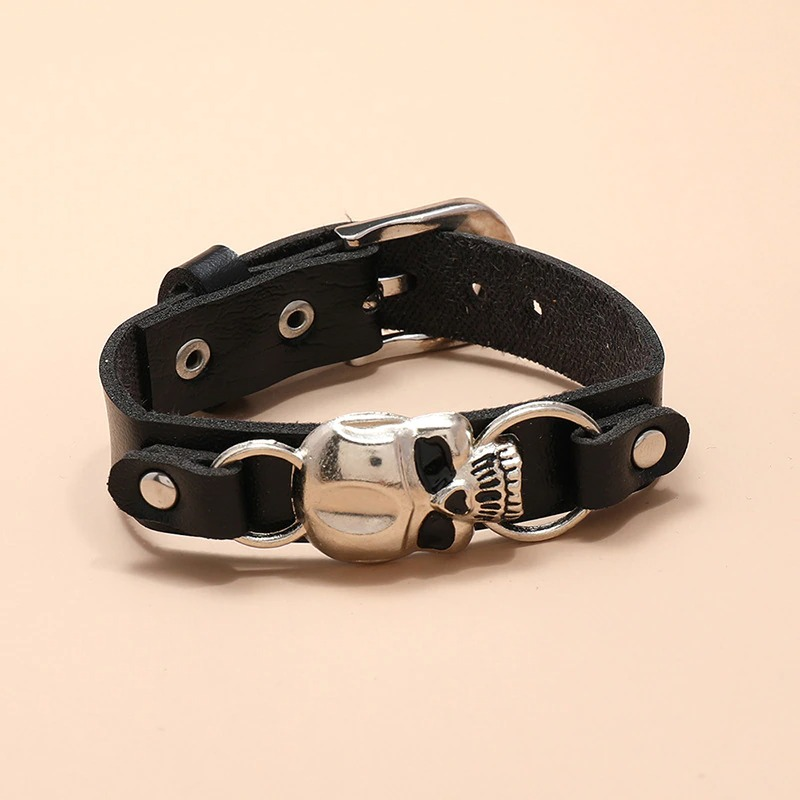 Gothic leather bracelet with silver skull detail, unisex jewelry accessory for stylish looks.