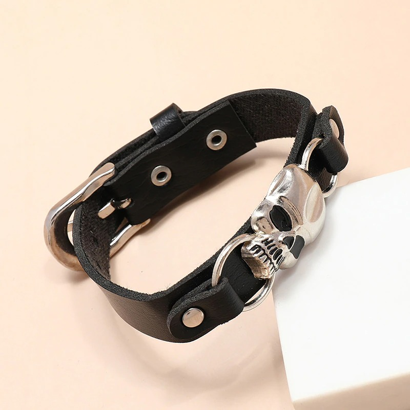 Stylish gothic leather bracelet for men and women featuring a silver skull centerpiece, perfect for edgy accessories.