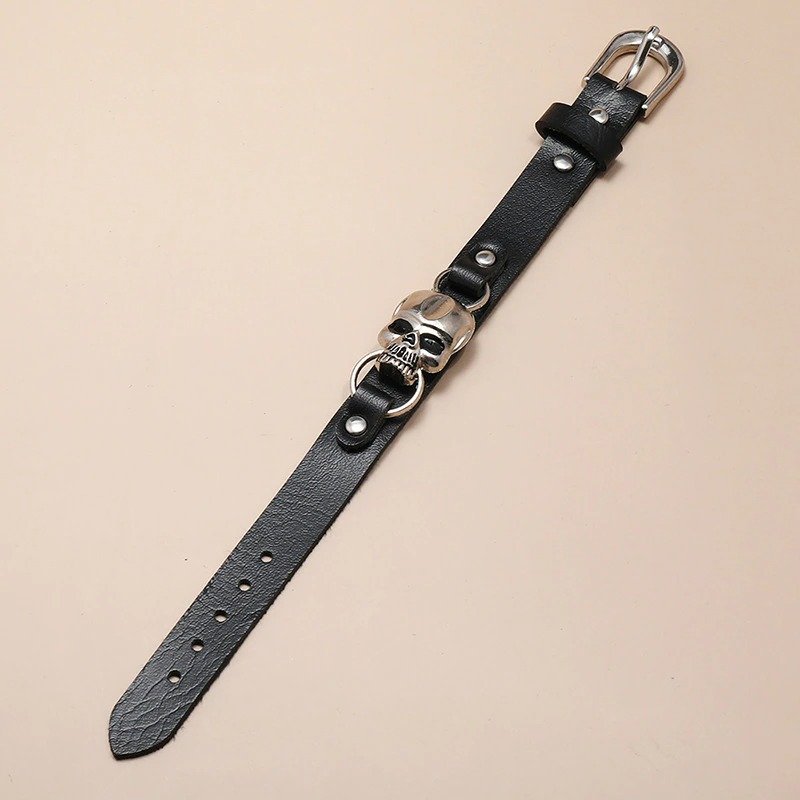 Stylish black leather bracelet with silver skull detail, perfect unisex gothic jewelry accessory.