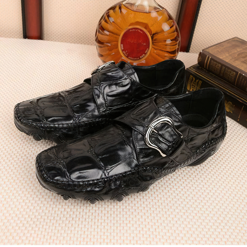 Black leather crocodile pattern loafers with trendy buckle, perfect for casual or formal occasions.