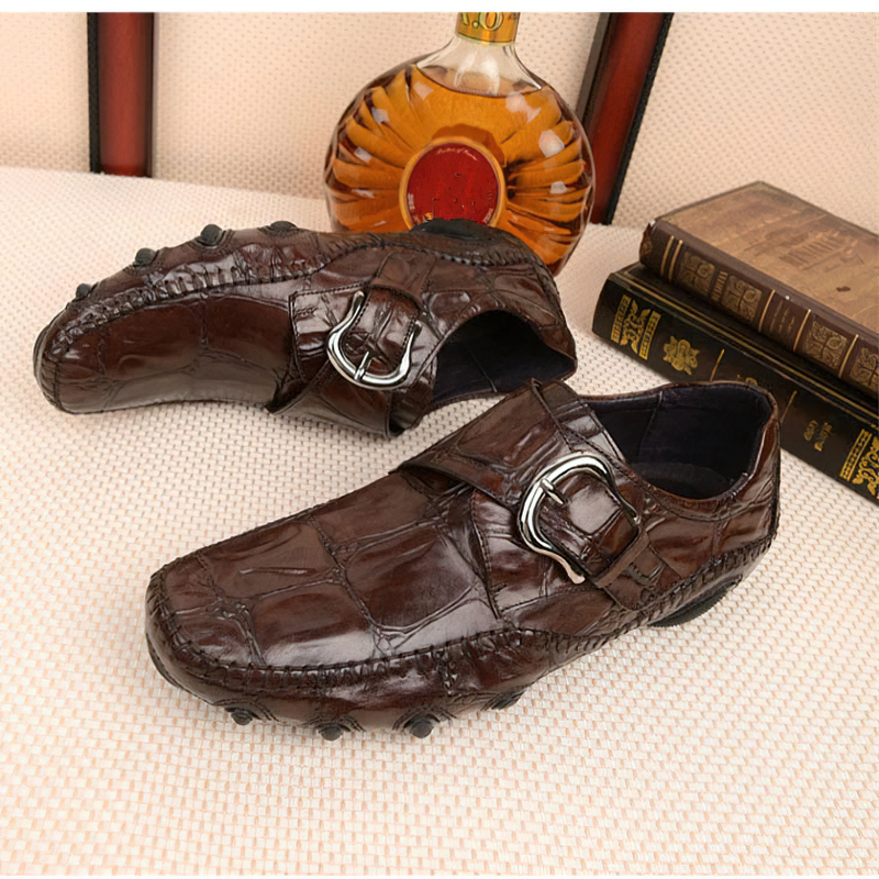 Brown leather crocodile pattern loafers with stylish buckle, perfect for casual or formal occasions.