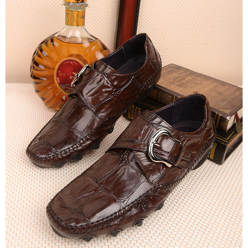 Brown leather crocodile pattern loafers with trendy buckle, perfect for casual men's fashion.