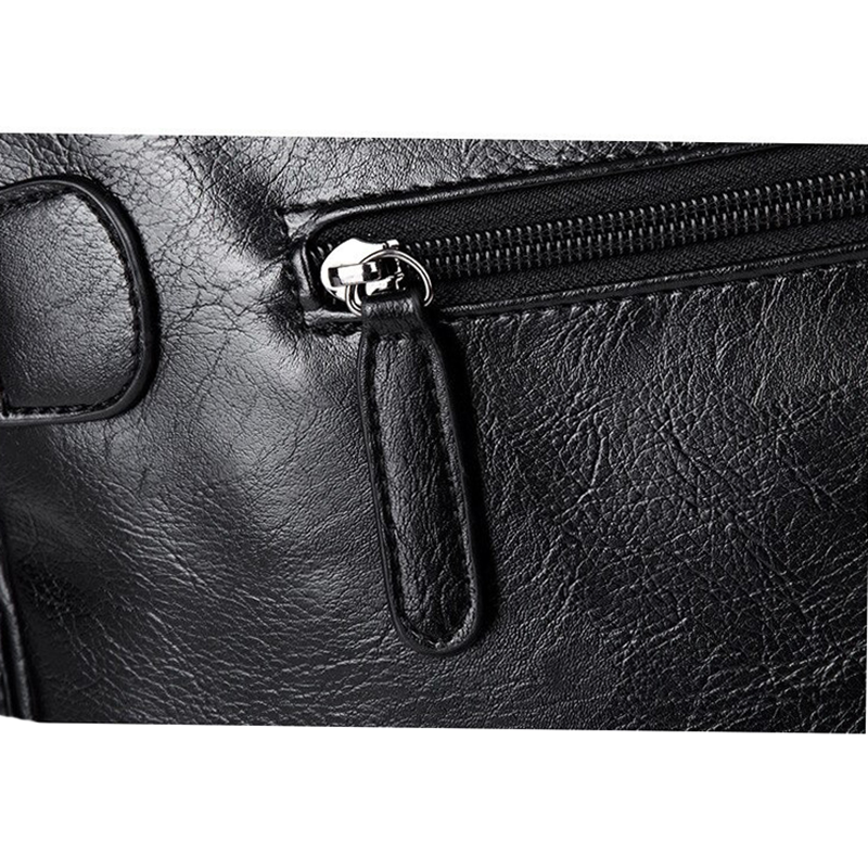 Close-up of the zipper detail on a men's faux leather gothic travel bag, showcasing its stylish craftsmanship.