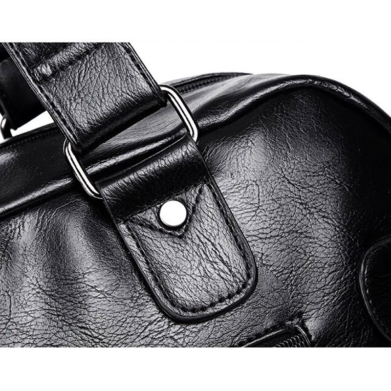 Close-up of a stylish black leather handbag strap, highlighting the gothic design and metal hardware for men's travel use.