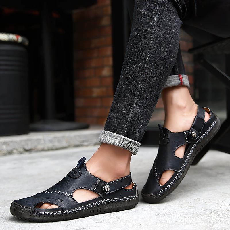 Men's black leather sandals showcasing stylish cutouts, perfect for summer beach outings and casual wear.