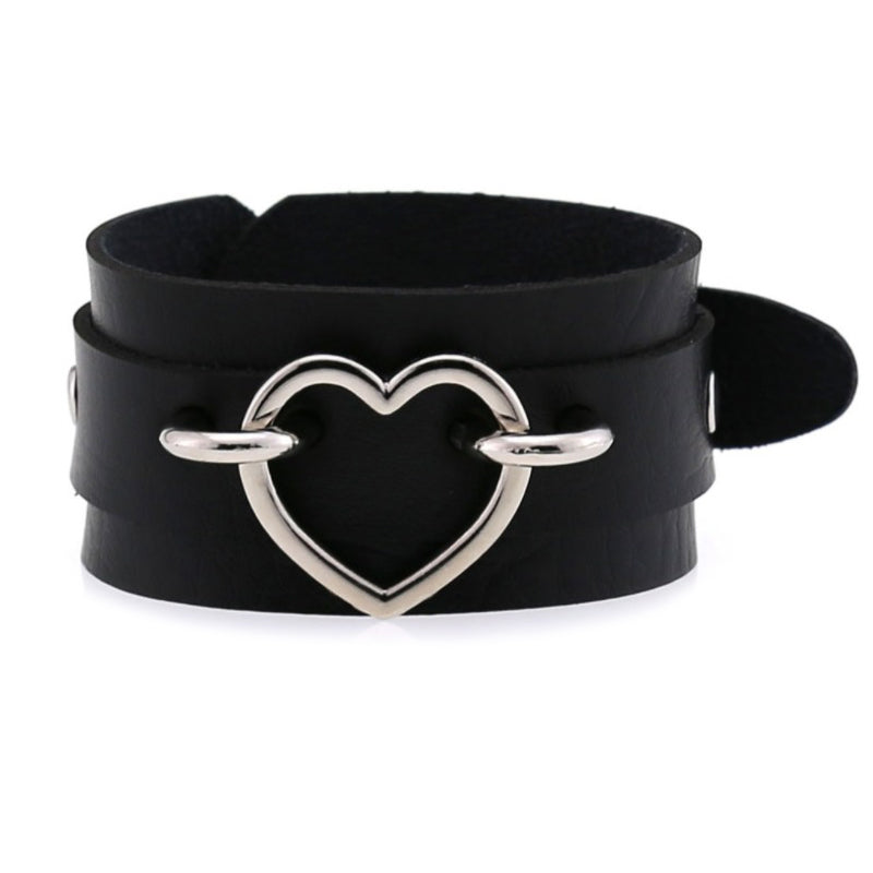 Black leather cuff bracelet with iron heart, stylish unisexual accessory for emo fashion lovers.