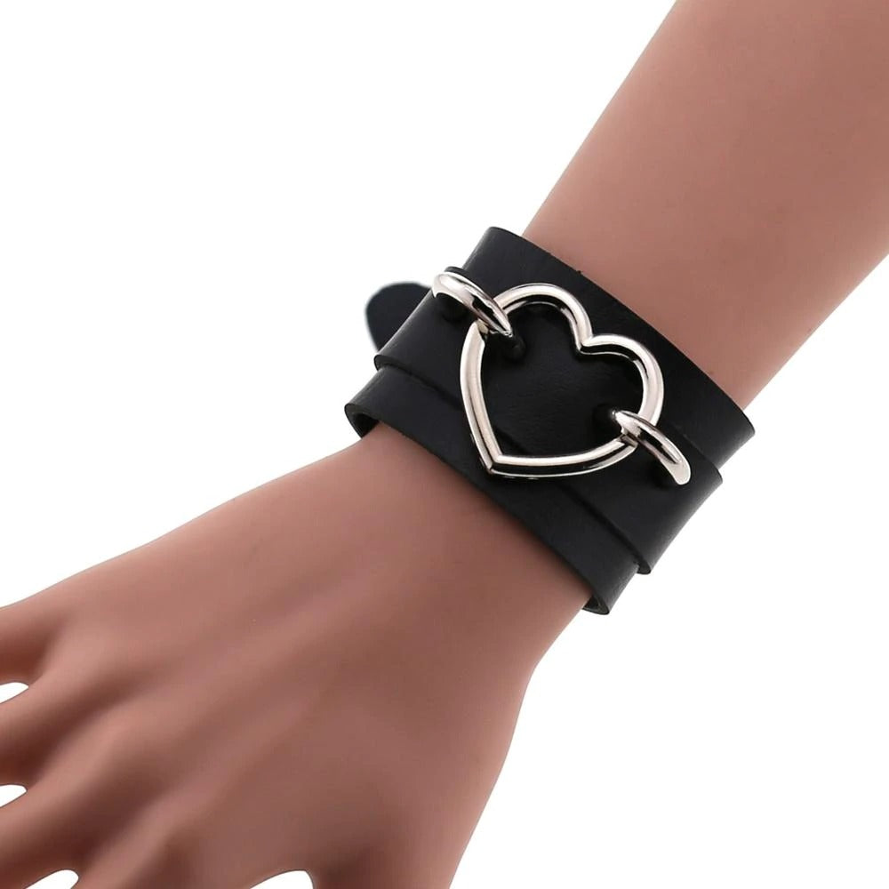 Black leather wristband cuff bracelet with heart charm, perfect for emo fashion for both men and women.