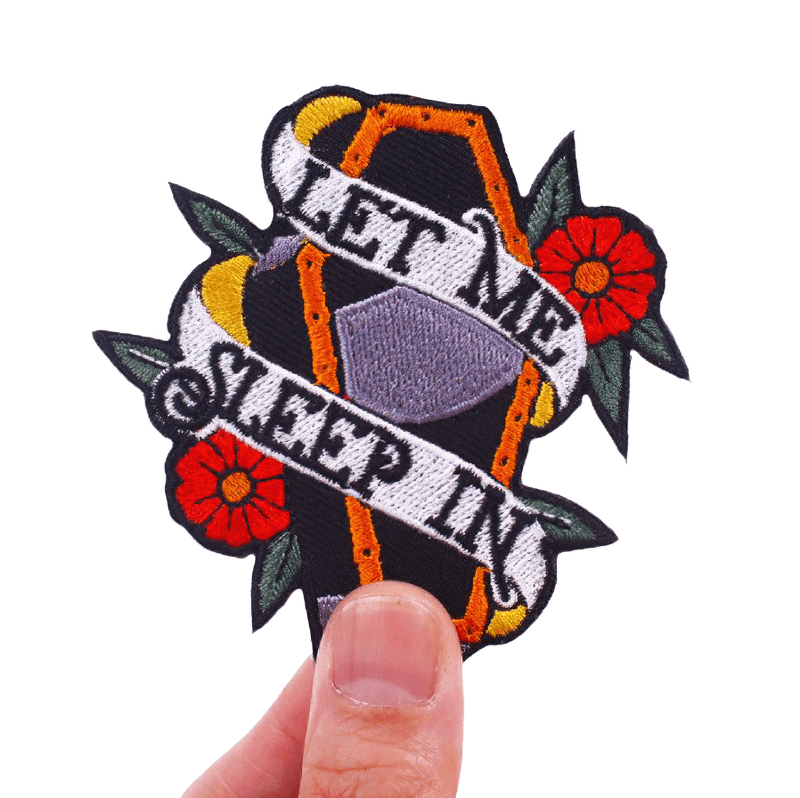 Unisex gothic patch featuring a coffin in flowers and text 'Let Me Sleep In', perfect for fashion accessories.