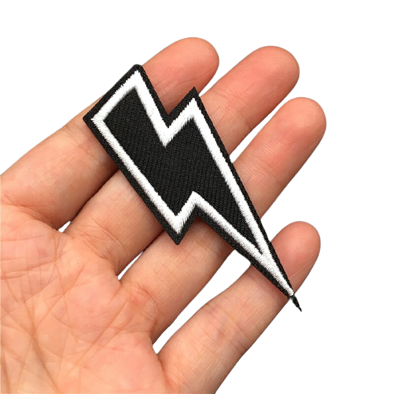 Lightning print iron-on patch in hand, unisex embroidered accessory for jackets and bags.