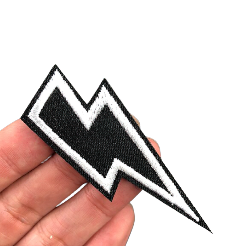 Unisex embroidered lightning print patch held in hand, perfect for jackets and bags as a stylish accessory.