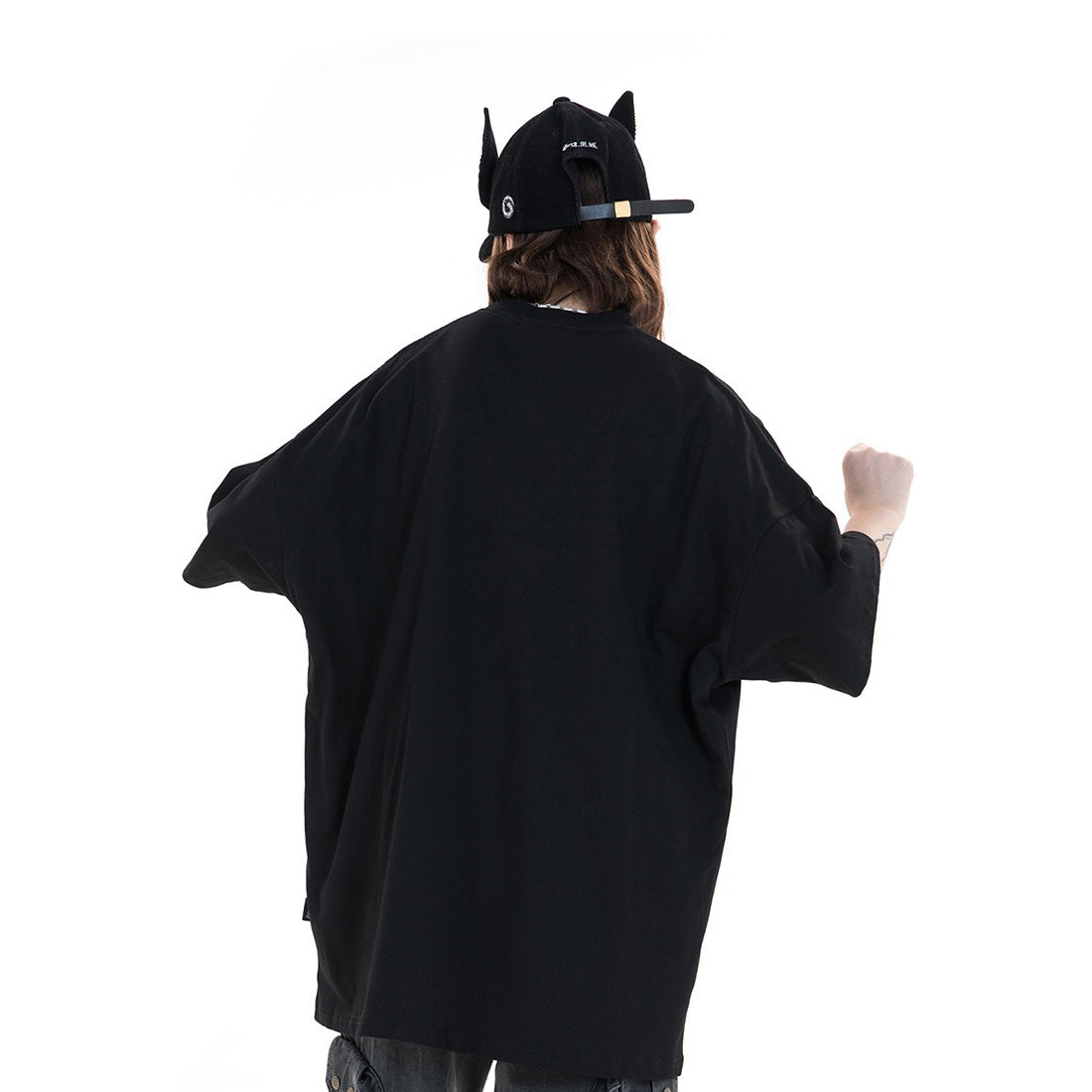 Black baggy Lightning Punk men's tee top seen from the back, styled with a cool cap for streetwear vibes.