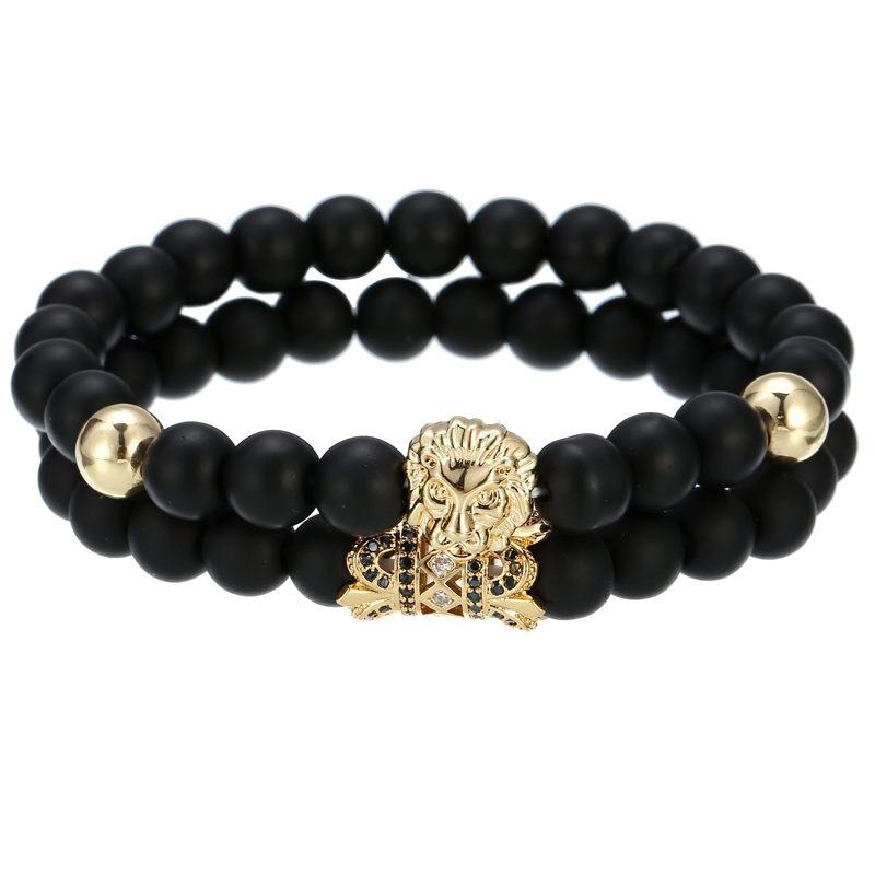 Stylish unisex lion bracelet with dark stone beads and gold crown detail, perfect for alternative fashion lovers.