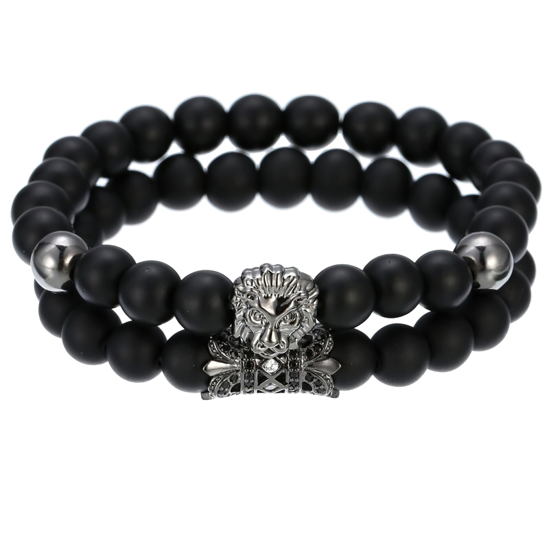 Unisex lion bracelet with dark stone beads and lion head crown charm, perfect for alternative fashion enthusiasts.