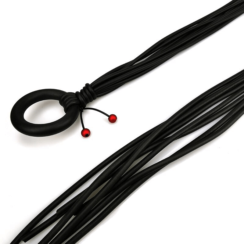 Long adjustable women's gothic necklace with red beads and black rubber design.