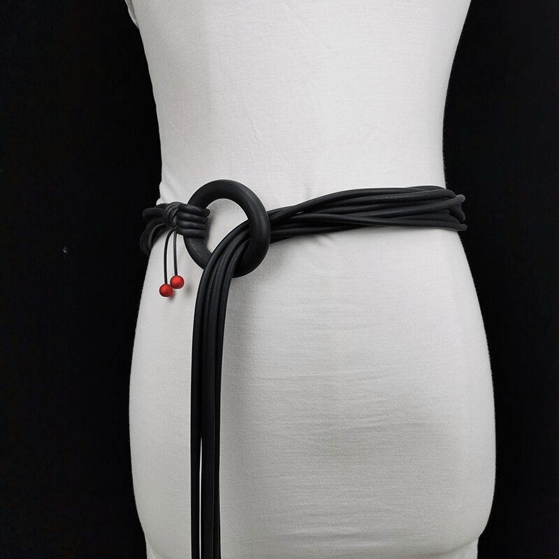 Stylish adjustable black rubber belt with red bead accents on a mannequin, perfect for gothic outfits.