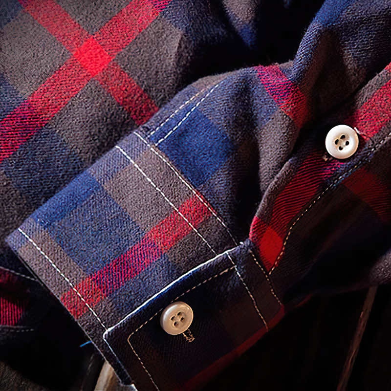 Close-up of a long sleeve plaid shirt showcasing buttons and cuffs in red and blue colors, perfect for a casual look.
