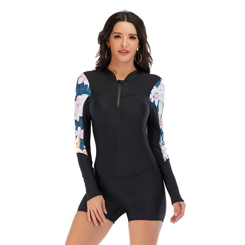 Long sleeve one-piece women's swimsuit with floral pattern and zipper for sporty summer swim fun.