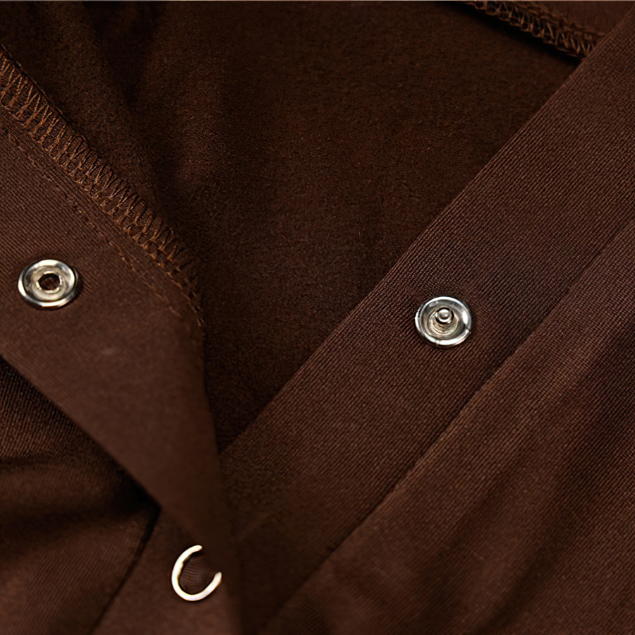 Close-up of brown fabric showing button details on a soft one-piece romper for women.