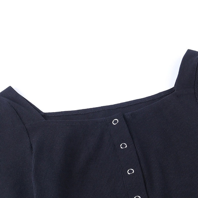 Close-up of the stylish buttons on a black ribbed women's bodysuit, perfect for rock and goth fashion.