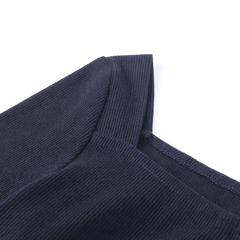 Close-up of the black ribbed fabric neckline of a women's bodysuit, showcasing its stylish and elegant design.