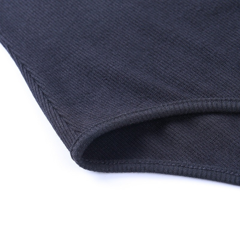 Close-up of a black ribbed fabric showing the hem of a women's sexy bodysuit with buttons, perfect for stylish outfits.