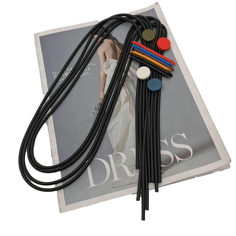 Stylish long tassel necklace for women with colorful rubber pendants on a fashion magazine.