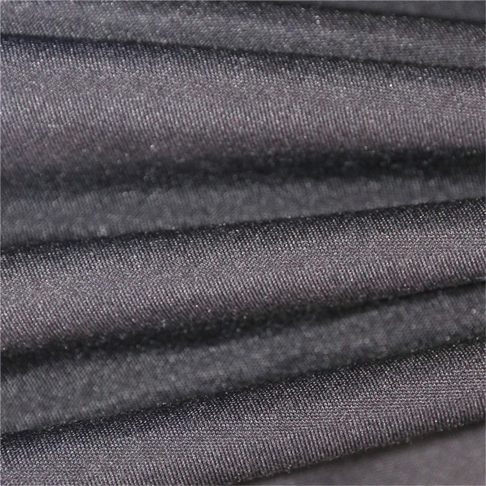 Close-up of luxurious black fabric, showcasing smooth texture and quality perfect for bedclothes.